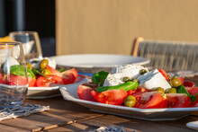 A Sun Kissed Table Presents A Classic Caprese Salad, With Mozzarella Cheese, Juicy Tomatoes, Green Olives, And A Sprinkle Of Capers, Epitomizing Italian Summer Lunch