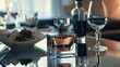 A square perfume bottle on a mirrored table, with an upside down wine glass, and two glasses, grey and black themes. Generative AI.