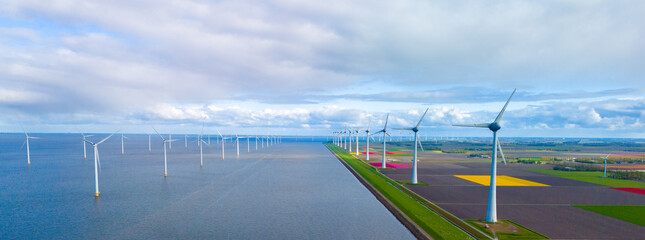 Wall Mural - A serene scene unfolds as wind mills stand tall around a vast lake, harnessing the power of the wind in the Netherlands during Spring