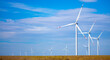 Fleet of power generators in motion. The blades of the wind farm rotate against the sky. The concept of extracting electricity from renewable sources. Wind turbine to generate electricity.