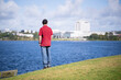 Man looking at the views across lake Pupuke. North Shore Hospital in the distance. Takapuna, Auckland.