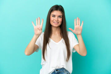 Wall Mural - Young caucasian woman isolated on blue background counting nine with fingers