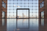 Fototapeta Miasta - Looking through a vast, contemporary glass window, a prominent glass door sits centrally, flanked by building structures on either side. In the background, silhouettes of harbor cranes and industrial 