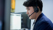 close up asian man call center agent wear headset device and  working in operation room with soling problem to client at desktop table for network engineering  and help desk concept	