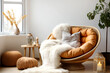 Fur throw on papasan chair against window. Scandinavian, hygge interior design of modern living room, home.