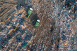 Aerial top down view of garbage trucks unload pile of waste at landfill. Dump of unsorted waste garbage pile in trash dump. Environmental pollution and ecological disaster. View from drone