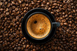Freshly Brewed Coffee in a Black Cup Surrounded by Coffee Beans
