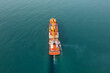 Aerial back view of cargo ship carrying containers for import and export, business logistic and transportation in open sea. Drone view. Freight shipping
