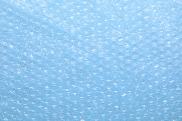 Wall Mural - Transparent bubble wrap on light blue background, top view