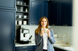 © BGStock72 - Confident Businesswoman Enjoying a Coffee Break in a Modern Office Kitchen