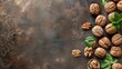 Walnuts and leaves scattered on textured, dark background
