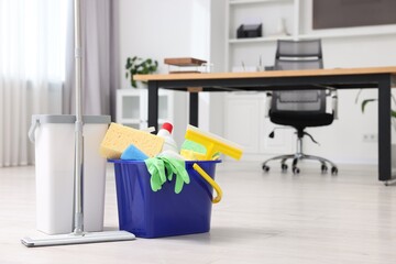 Canvas Print - Cleaning service. Mop and bucket with supplies in office, space for text