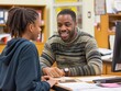 © MaxK - A man and a woman are talking at a desk. The man is smiling and the woman is smiling back
