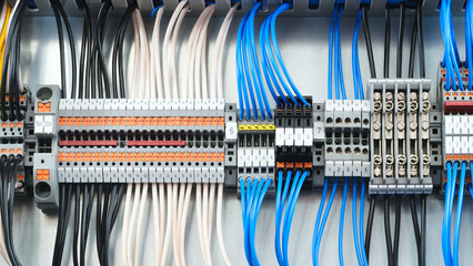 Poster - A blue and white electrical box with many wires and a green switch