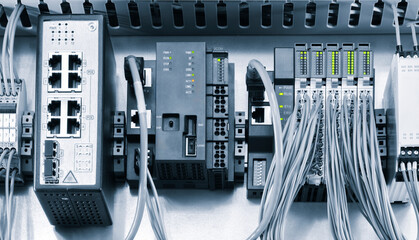 Poster - A blue and white electrical box with many wires and a green switch