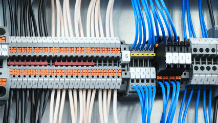 Poster - A blue and white electrical box with many wires and a green switch
