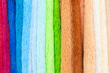 Poster - A row of towels with different colors and patterns. The towels are arranged in a row, with the lightest color on the left and the darkest on the right. The towels are all different sizes and shapes