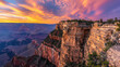 © boxstock production - Mountain cliff edge overlooking epic canyon landscape at sunrise with beautiful colorful sky and clouds