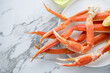 Boiled legs and claws of opilio or snow crab on a white marble background, horizontal shot with space