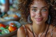 Attractive curly-haired woman with a fresh look and natural makeup sitting in a cafe