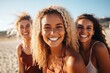 three women on the beach smiling