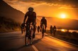 cyclists riding on the street at sunset