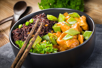 Canvas Print - Thai red curry with chicken and black rice.