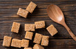 Brown sugar cubes. Natural brown sugar cubes on wood background. Top view point.