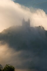 Wall Mural - Natural scene with rapidly changing weather, evaporation of water after a storm, historical building in the background