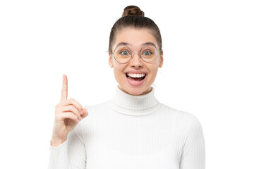 Excited smiling woman in eyeglasses pointing up with finger as if she got new idea, feeling happy about good result