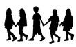 Vector silhouettes of  boy and a girls, a group of walking   shildren, profile, black  color isolated on white background