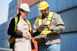 Middle east logistic worker foreman finger point with caucasian logistic worker pregnant woman at container site