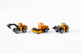 Fototapeta Paryż - Yellow and black toys of public works vehicles on a white background