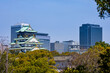 view of osaka castle with modern skyscrapers in the background