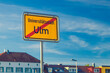 Bright yellow traffic sign indicating the city limits of Ulm, Germany. The sign reads Universitätsstadt (University city) Ulm.