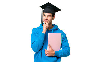 Wall Mural - Young university graduate man over isolated background having doubts and thinking