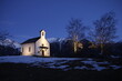 Small church in the mountains at night in the snow