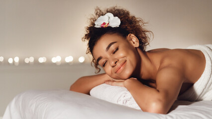 Wall Mural - Massage. African-american girl relaxing in spa salon