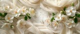 A classic pearl white marble surface adorned with white jasmine flowers and sheer white silk. 