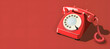 Vintage Red Telephone on Red Background.