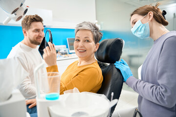 Wall Mural - Mature woman grateful with healthy clean smile, aesthetic dentistry