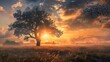 A majestic tree stands alone in a field with the sun setting (or rising) directly behind it, creating a striking backlight that illuminates the tree's leaves and the surrounding misty landscape. The g
