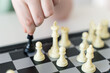 A child's hand holds a chess piece. Ira in chess. Close-up. Selected Focus