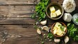 Butter cubes in bowl with herbs on wooden background
