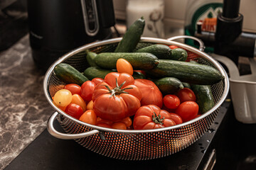 Wall Mural - fresh healthy organic tomatoes and cucumbers in strainer