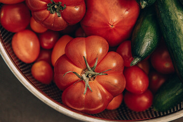 Wall Mural - fresh healthy organic tomatoes and cucumbers in strainer