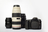 Fototapeta Młodzieżowe - DSLR digital SLR camera with a set of lenses including macro, tele and wide angle, isolated on a white background