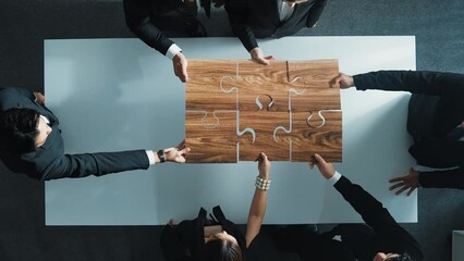 Wall Mural - Top view of skilled businesspeople hand bring and fill the last jigsaw piece together. Group of project manager complete puzzle or solving problem. Unity, teamwork, successful project. Directorate.