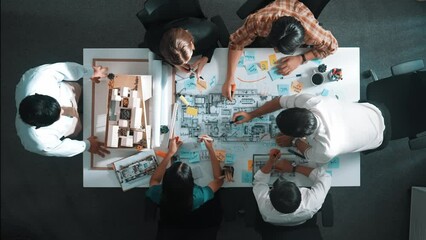 Wall Mural - Top aerial view of project manager or civil engineer writing at blueprint and planning building design. Aerial view of architect working together at meeting table with document placed. Alimentation.