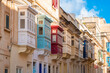 Cozy street and traditional colorful wooden balconies in Sliema, Malta